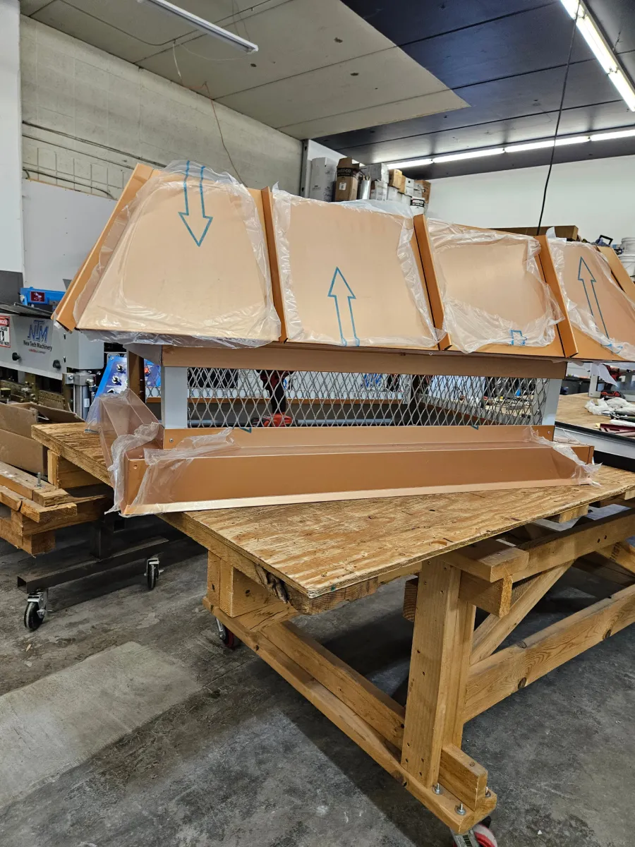 Broken cardboard shipping crate on wooden pallet in a warehouse, wrapped and strapped for transport