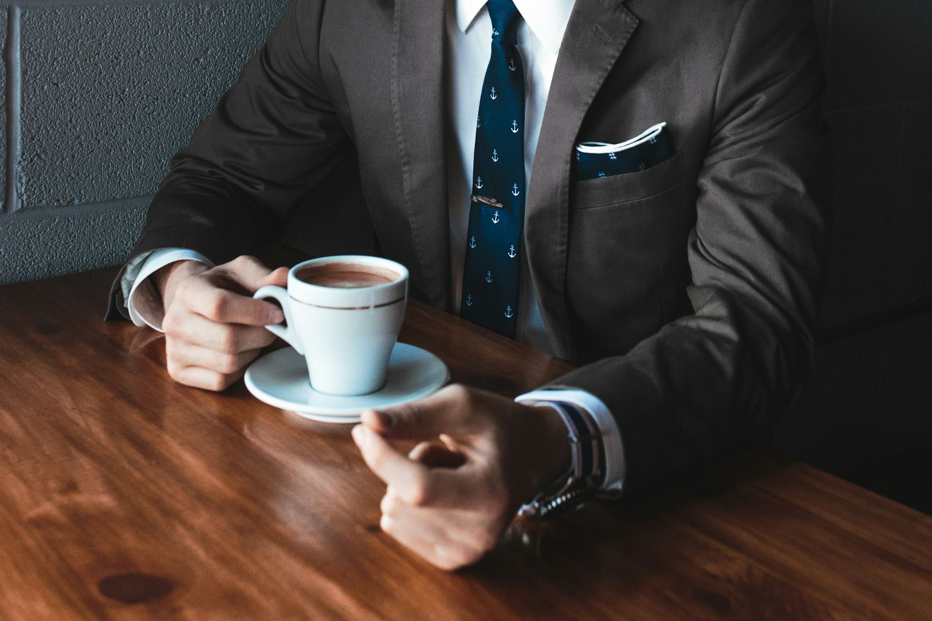 Homem de terno tomando café