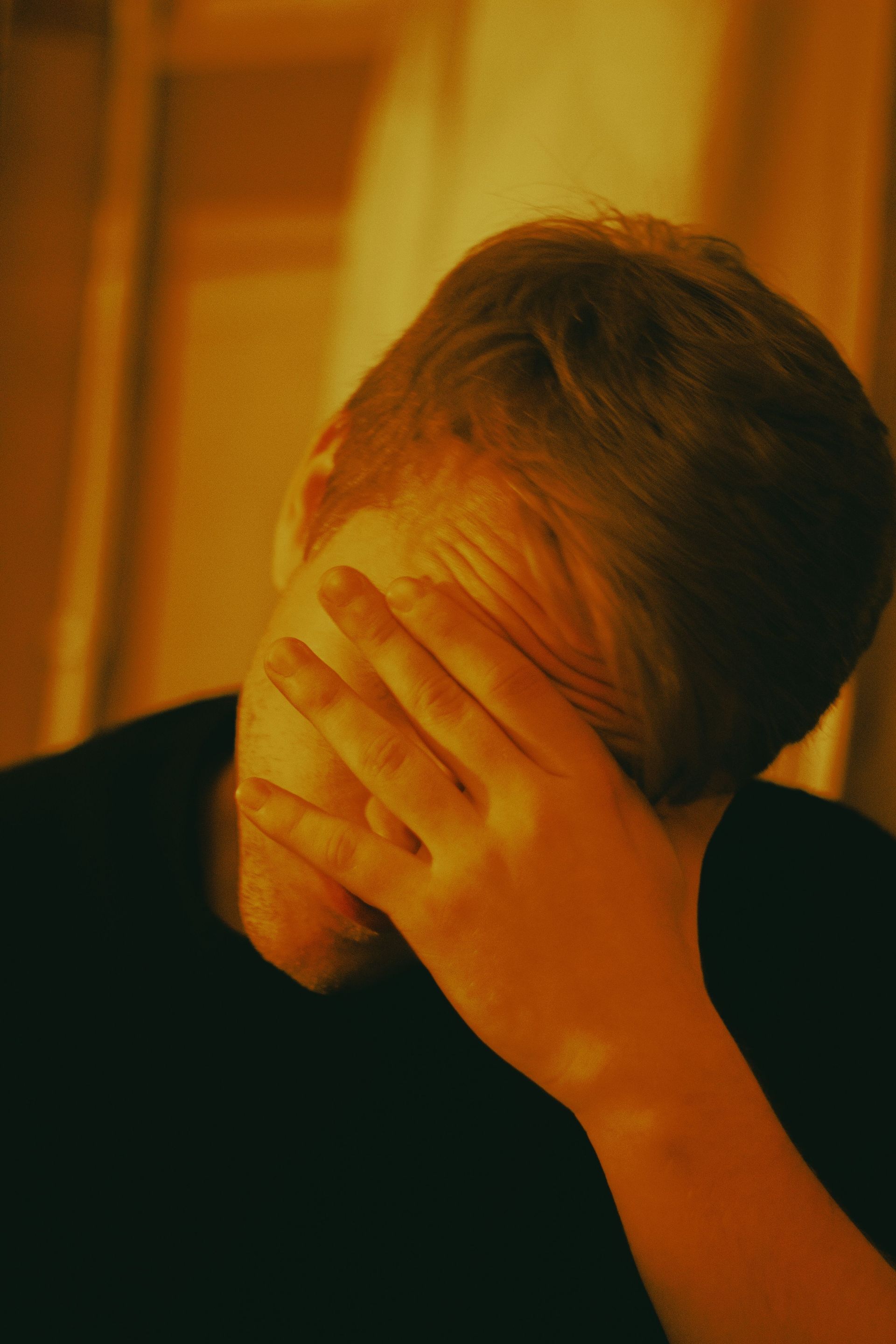 Person turned inward, processing difficult emotions alone