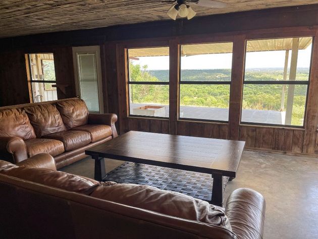 living room with windows looking over valley of trees