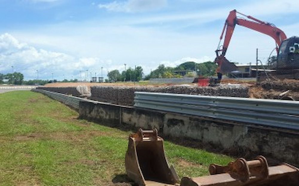 A Construction Site With a Red Excavator and a Red Excavator — Diggamen Civil Contracting in Tivendale, NT