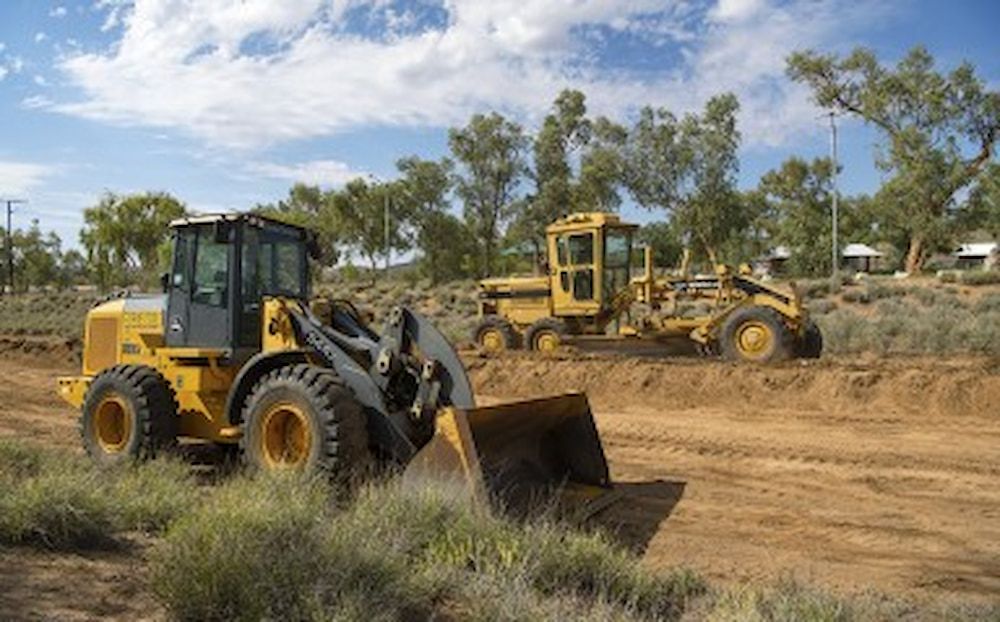 A Yellow Bulldozer is Parked in a Parking Lot — Diggamen Civil Contracting in Tivendale, NT