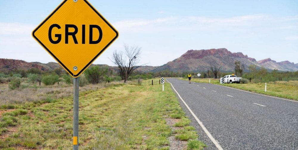 A Yellow Sign on the Side of a Road That Says Grid — Diggamen Civil Contracting in Tivendale, NT