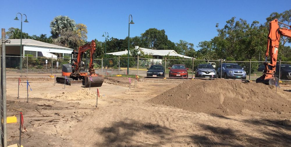 A Construction Site With a Lot of Dirt and Cars Parked in the Background — Diggamen Civil Contracting in Tivendale, NT