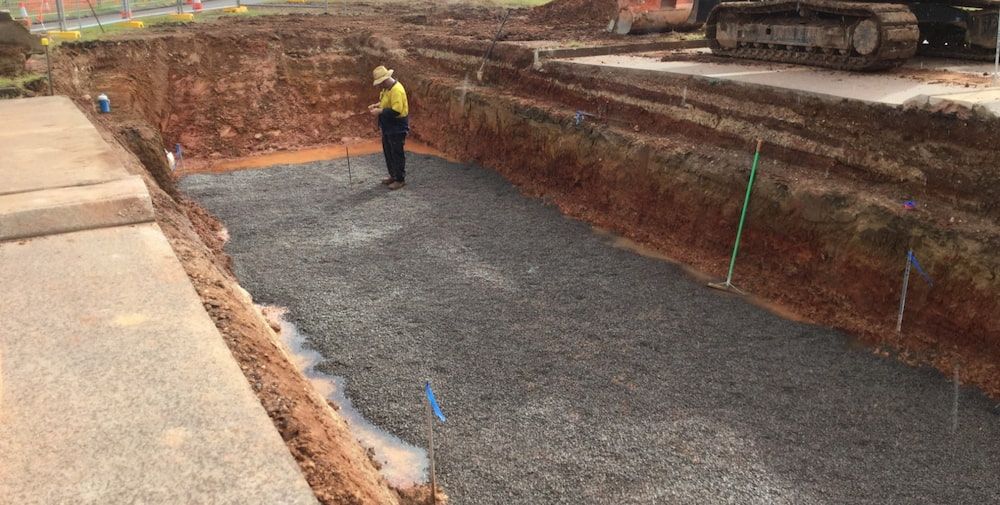 A Man is Standing in the Middle of a Dirt Field — Diggamen Civil Contracting in Tivendale, NT