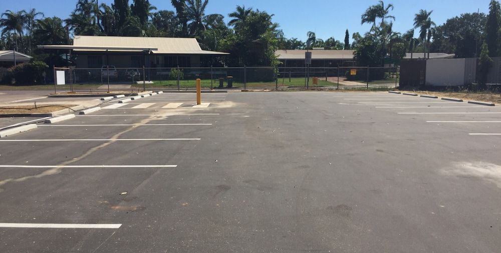 An Empty Parking Lot With a House in the Background — Diggamen Civil Contracting in Tivendale, NT