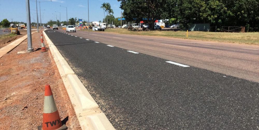 A Road With a Traffic Cone on the Side of It — Diggamen Civil Contracting in Tivendale, NT