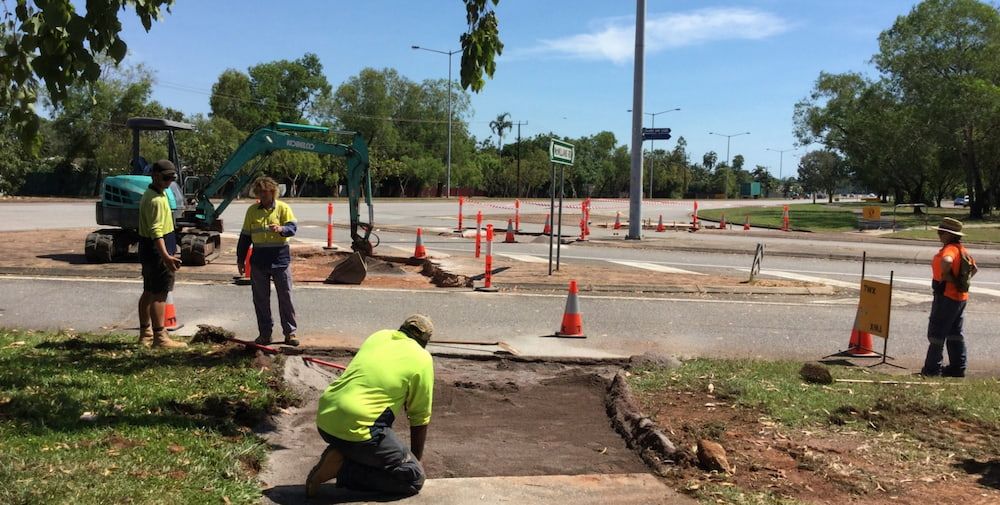 A Group of Construction Workers Are Working on a Sidewalk — Diggamen Civil Contracting in Tivendale, NT