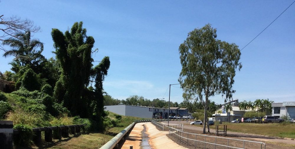 A Train Track With Trees on the Side of It and a Blue Sky in the Background — Diggamen Civil Contracting in Tivendale, NT