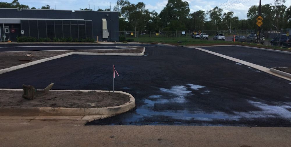 A Parking Lot is Being Built in Front of a Building — Diggamen Civil Contracting in Tivendale, NT