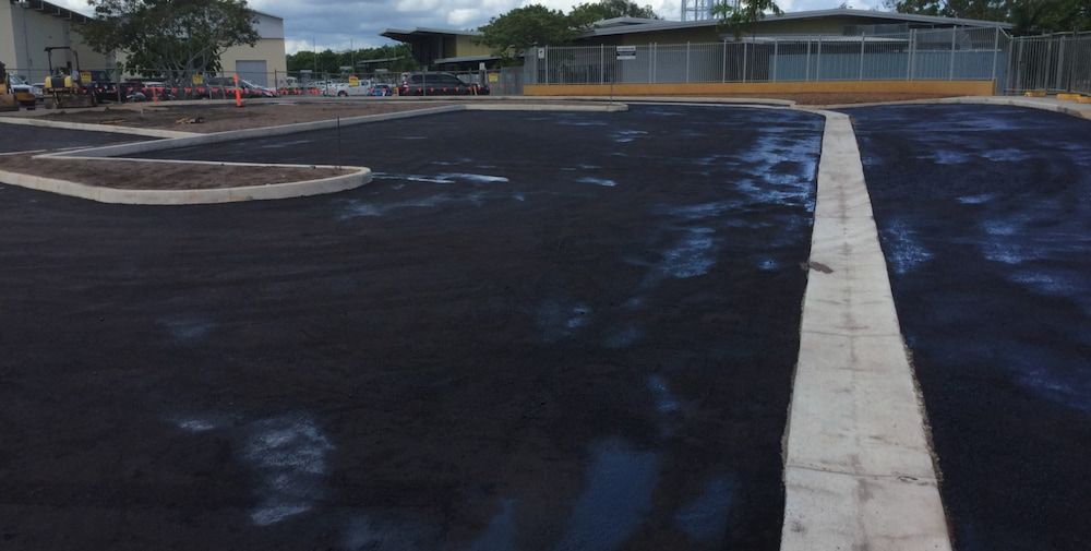 A Parking Lot With a White Line in the Middle of It — Diggamen Civil Contracting in Tivendale, NT