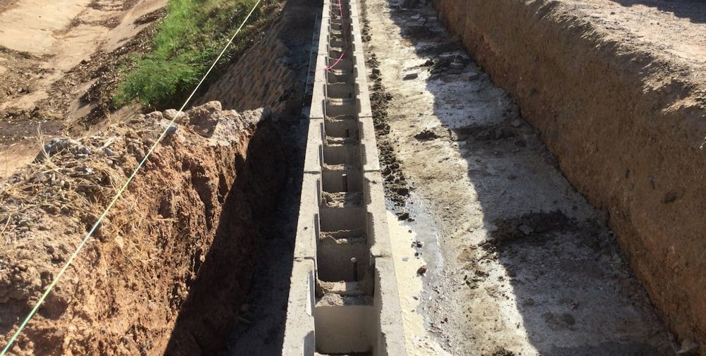 A Concrete Wall is Being Built in a Trench — Diggamen Civil Contracting in Tivendale, NT