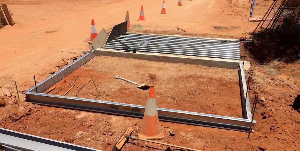 A Construction Site With Cones and a Metal Frame in the Dirt — Diggamen Civil Contracting in Tivendale, NT