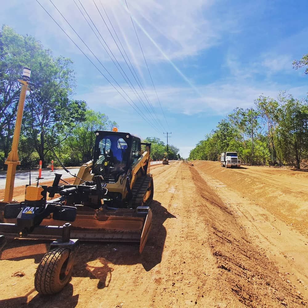A Bulldozer Is Working on A Dirt Road — Diggamen Civil Contracting in Tennant Creek, NT