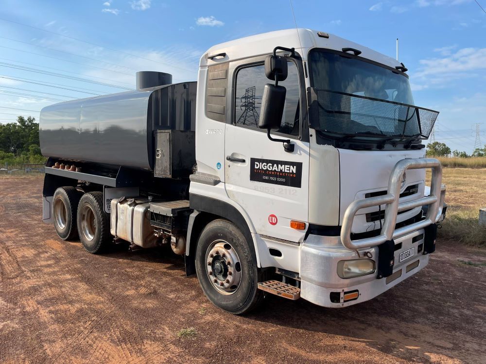 A White and Black Truck Is Parked in A Dirt Field — Diggamen Civil Contracting in Katherine, NT 