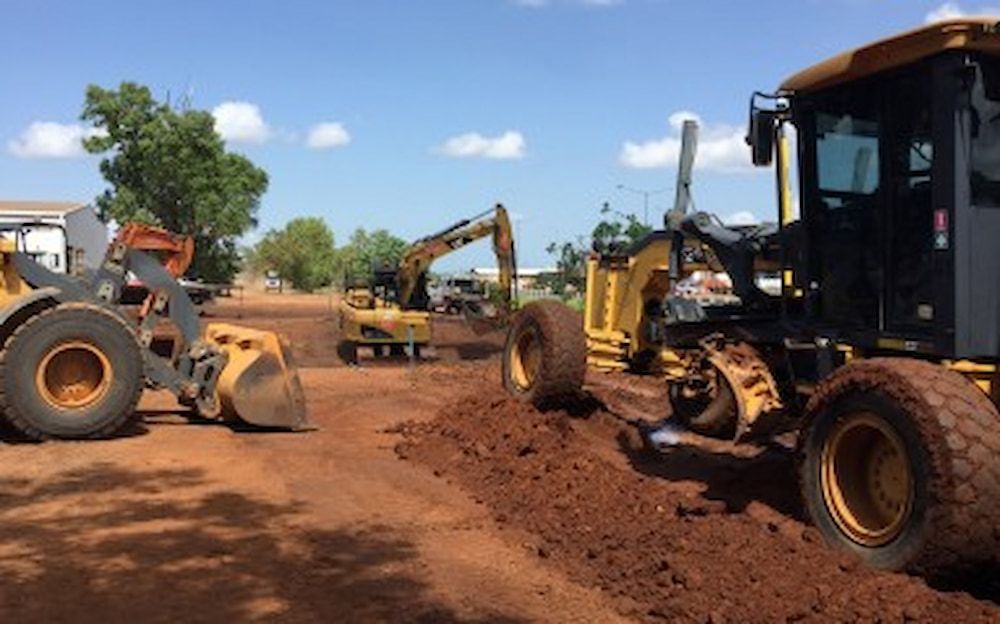 A Group of Construction Vehicles Are Working on A Dirt Road — Diggamen Civil Contracting in Humpty Doo, NT