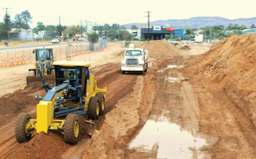 A Construction Site With a Yellow Grader — Diggamen Civil Contracting in Tivendale, NT