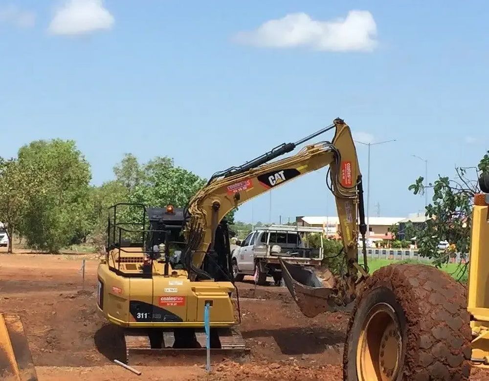 A Yellow Excavator with The Word Cat on It — Diggamen Civil Contracting in Katherine, NT