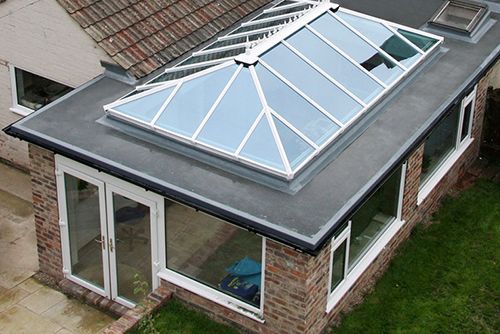 An aerial view of a house with a skylight on the roof