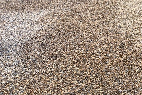 A close up of a pile of gravel on the ground.