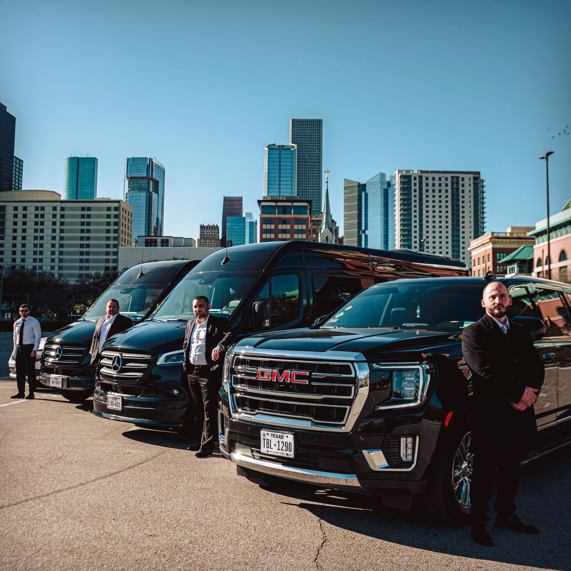 Black luxury SUV chauffeur service with Houston skyline near Hobby Airport