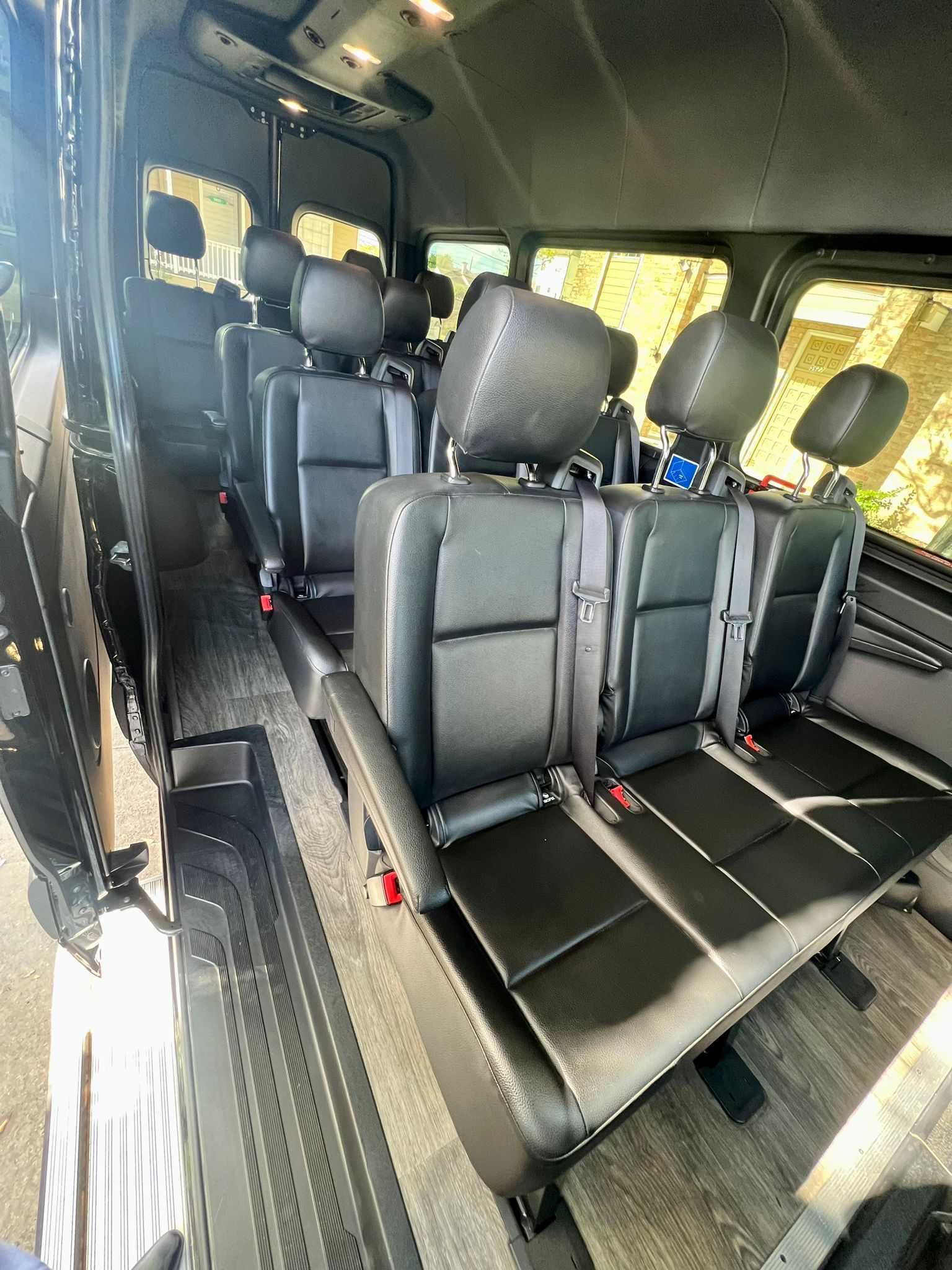 The inside of a van with a lot of seats and headrests.