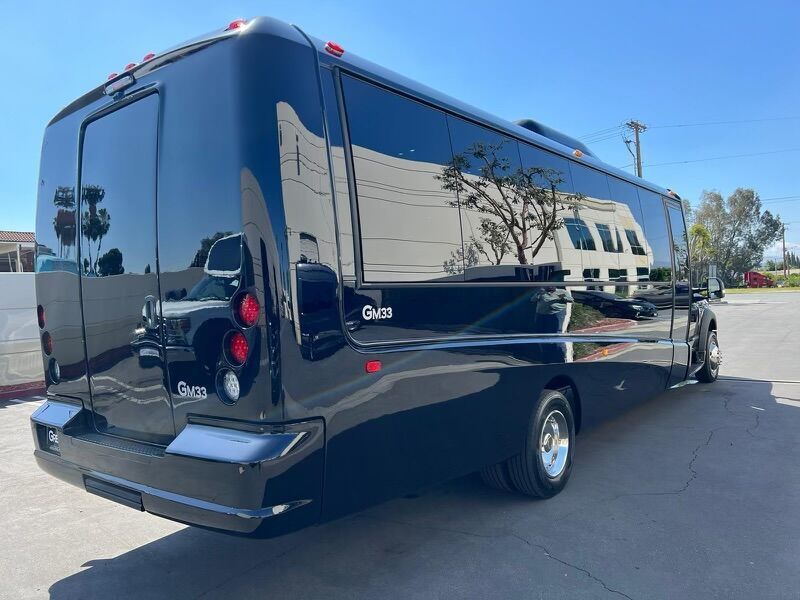 A black limousine is parked in a parking lot.