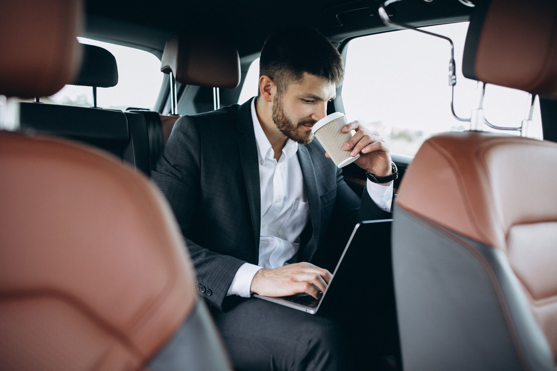 Business executive working in chauffeured vehicle