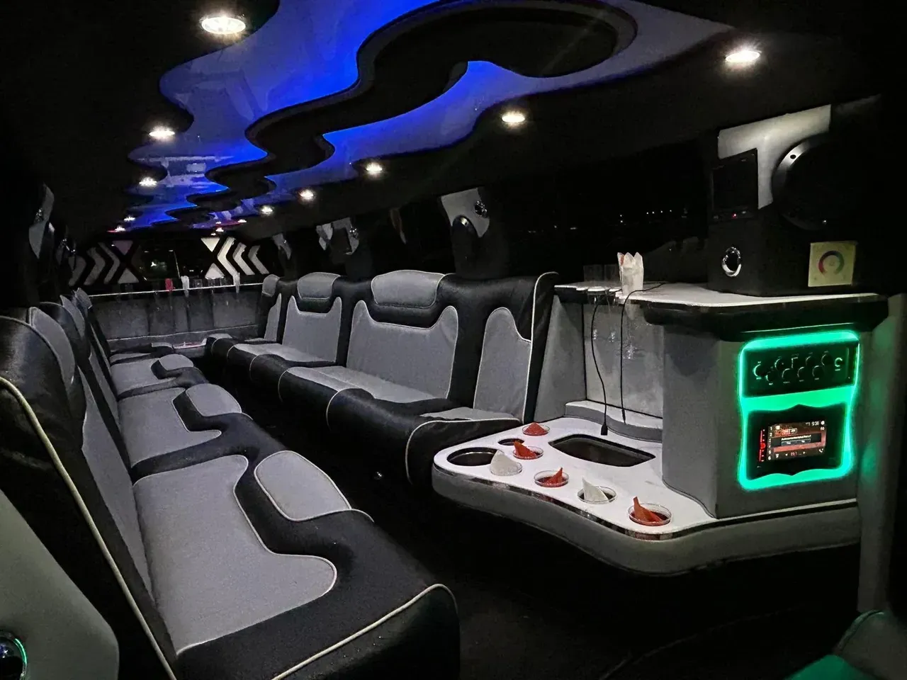 The inside of a limousine with lots of seats and a table