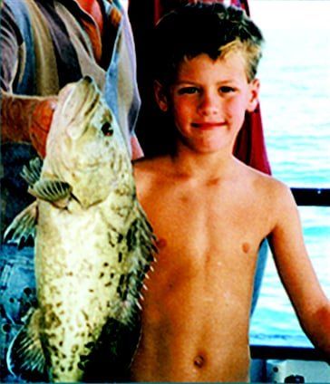 Shirtless Kid with Fish — Fort Myers, FL — Captain Tony’s Fishing Adventures