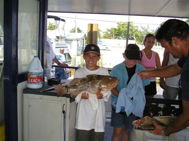 Kid Holding Big Fish — Fort Myers, FL — Captain Tony’s Fishing Adventures