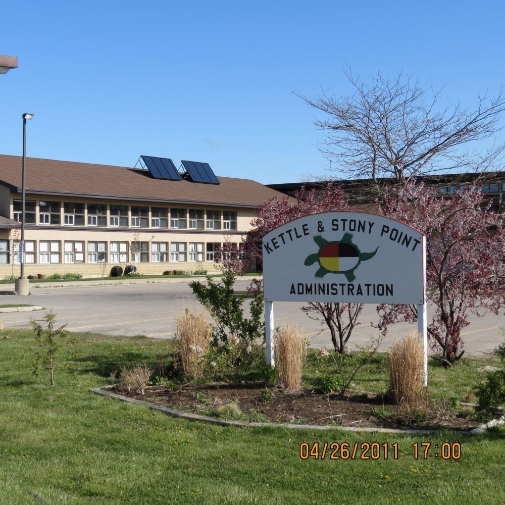 Mettler & Stony Point Administration building sign in front of a two-story school building under a blue sky