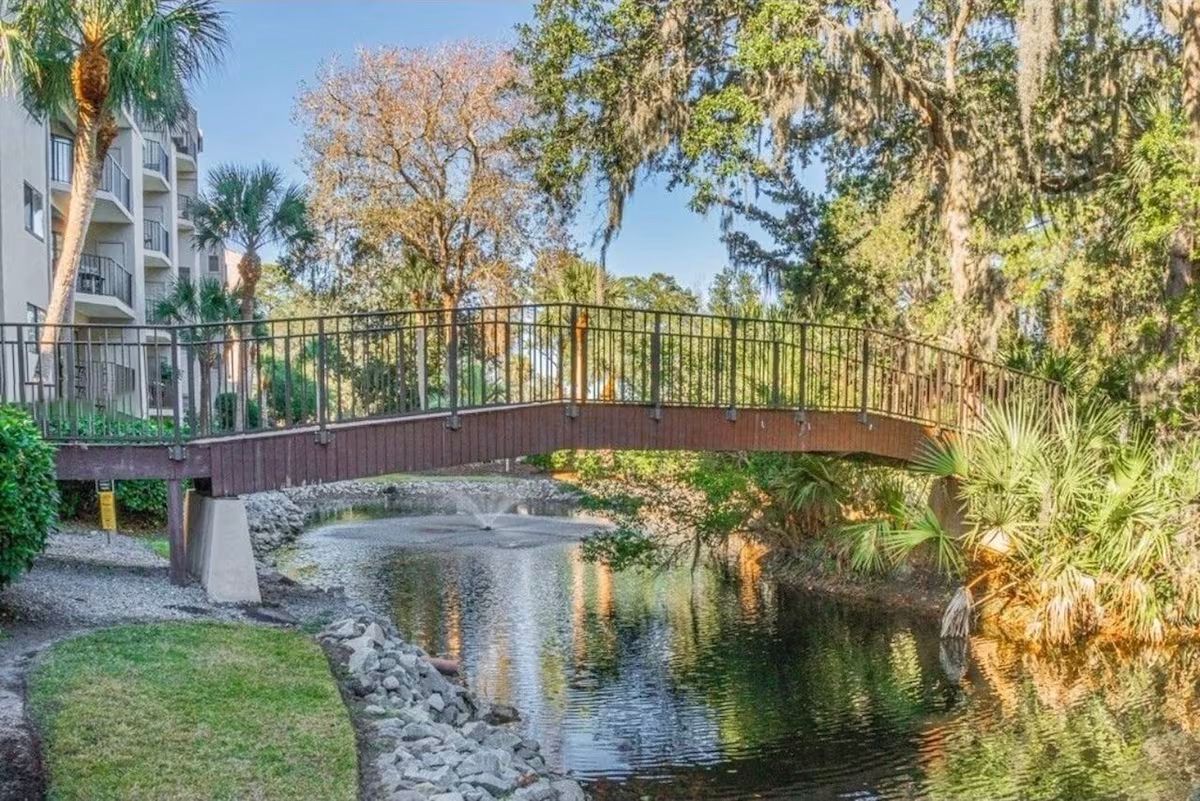 Bridge over beautiful pond at the villa complex near Coligny Beach.