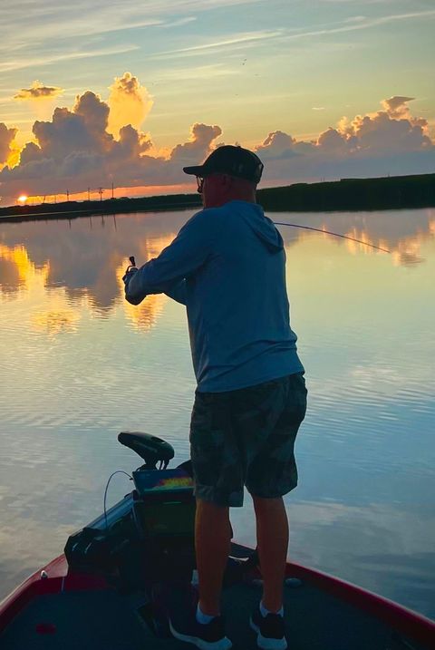A grandfather and his grandson fishing together on the boat