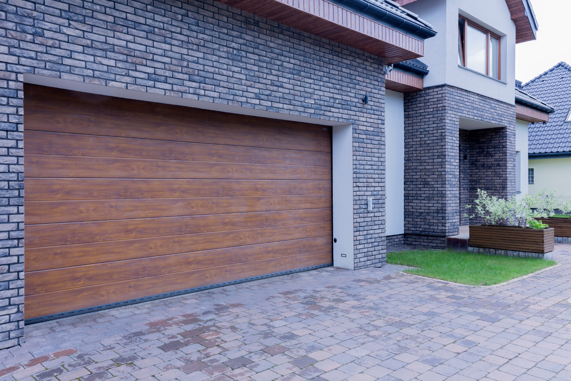 A large brick house with a wooden garage door
