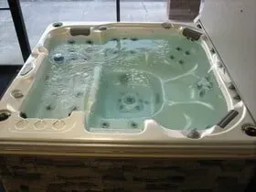 A large white hot tub filled with water in a room.