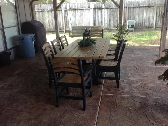 A patio with a table and chairs under a canopy