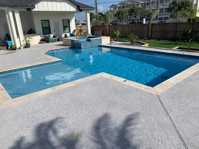 A large swimming pool in the backyard of a house