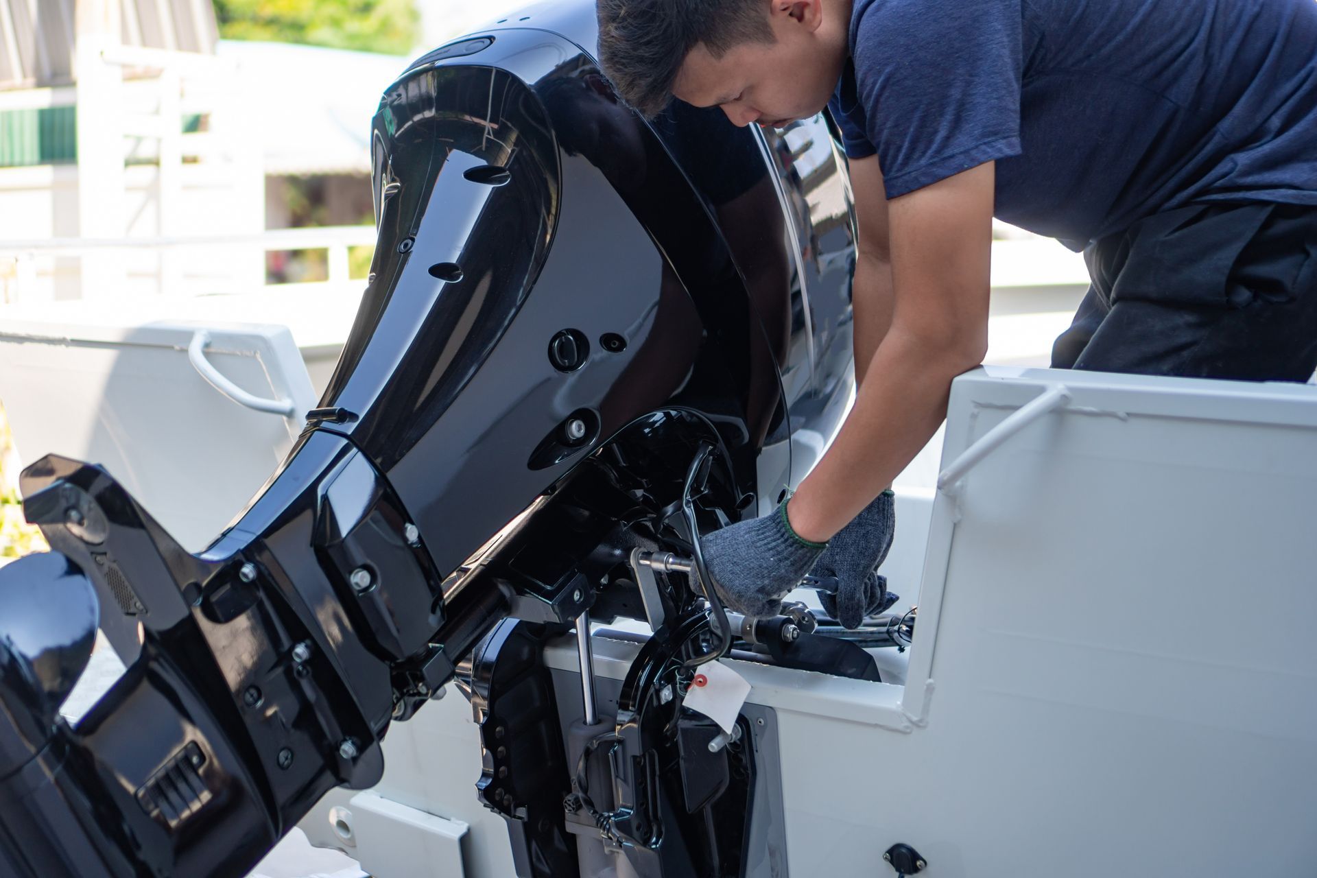 Mechanic is installing speed boat engine.