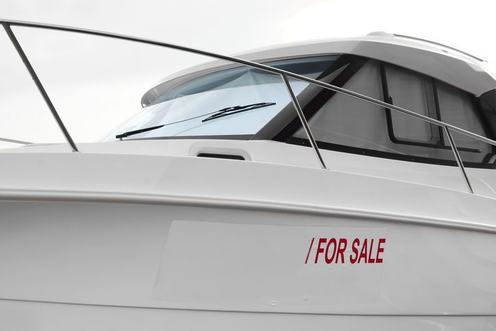 White boat with FOR SALE sign