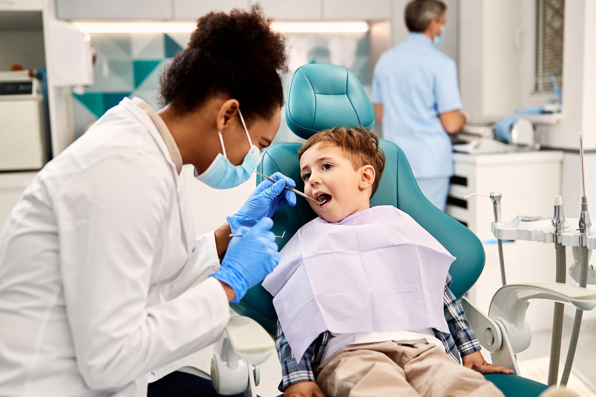 Dentist examining a child in a dental chair during a checkup