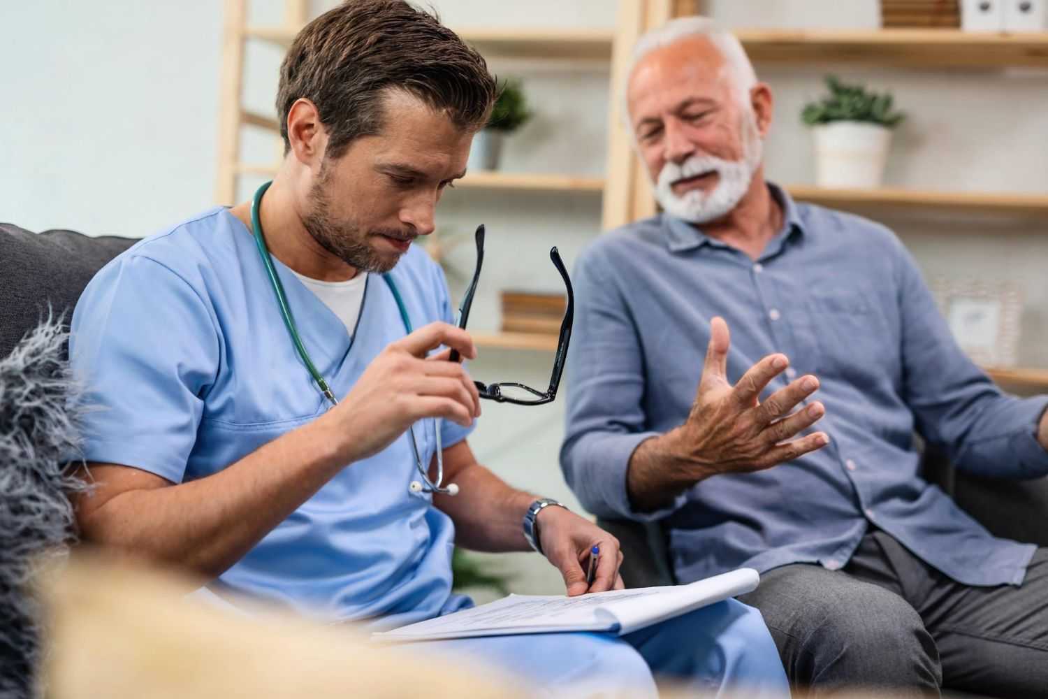 Doctor in white coat, stethoscope, holding 
