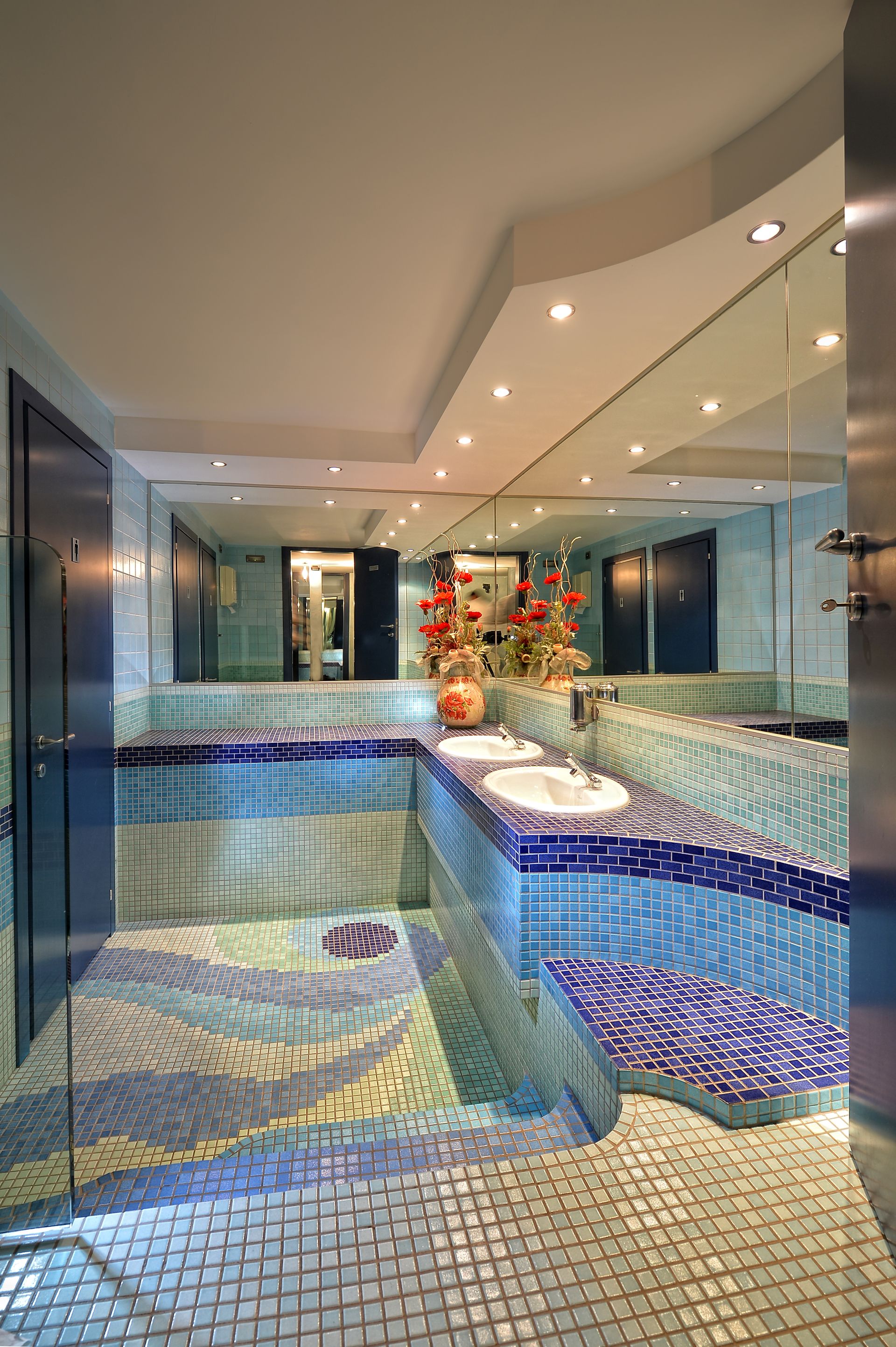 A bathroom with two sinks and a large mirror.