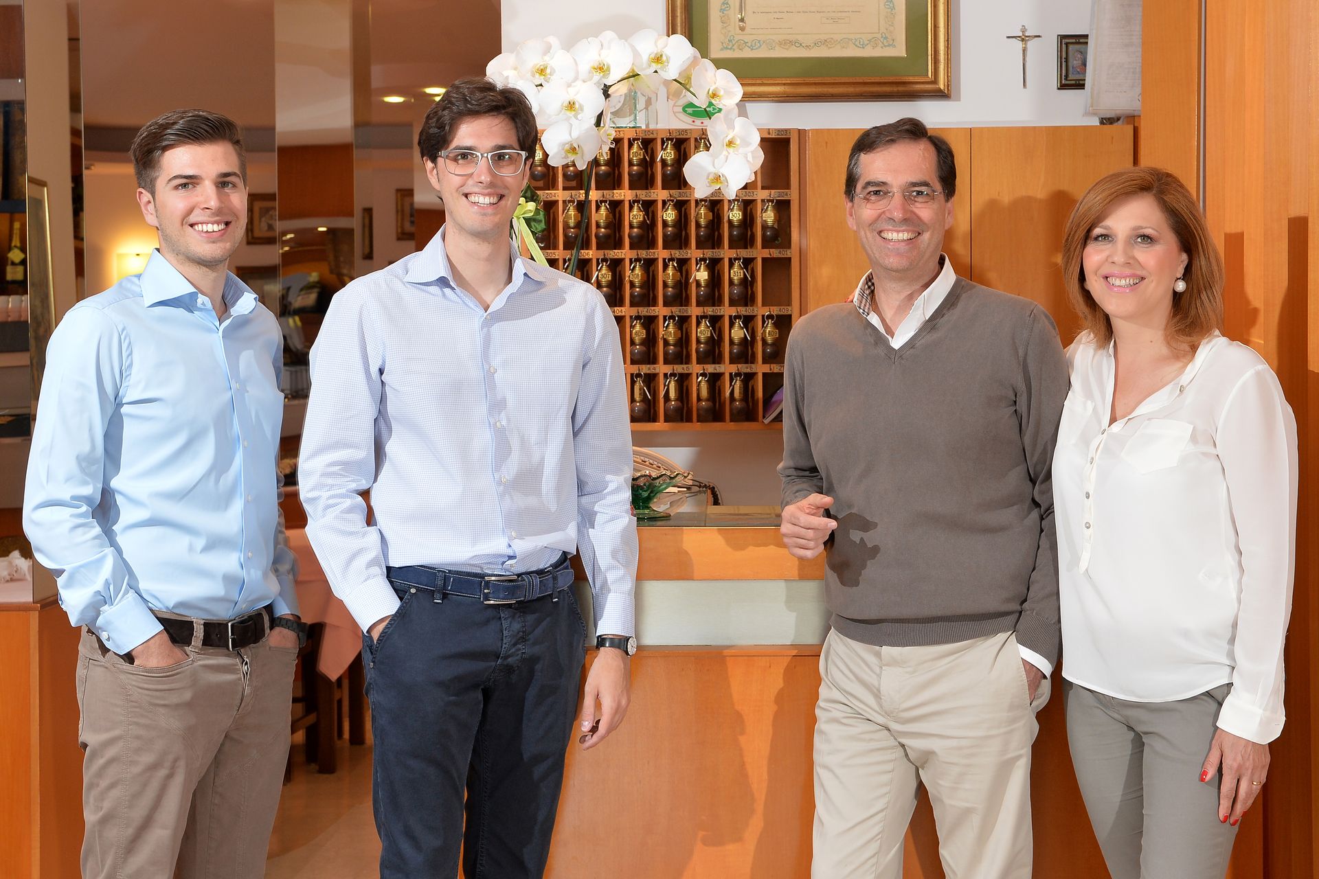 A family posing for a picture in front of a hotel counter