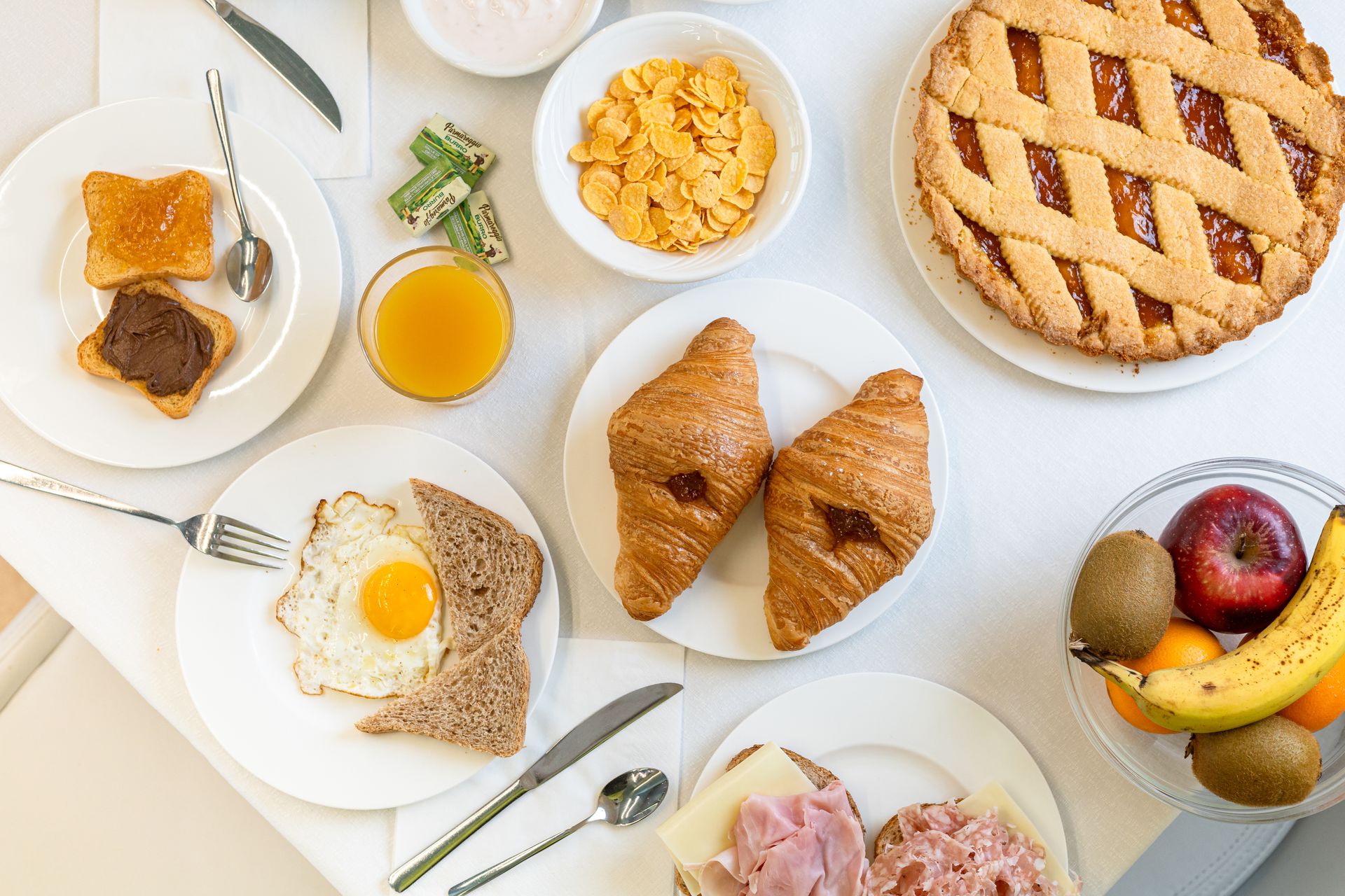 A table topped with plates of food and fruit.