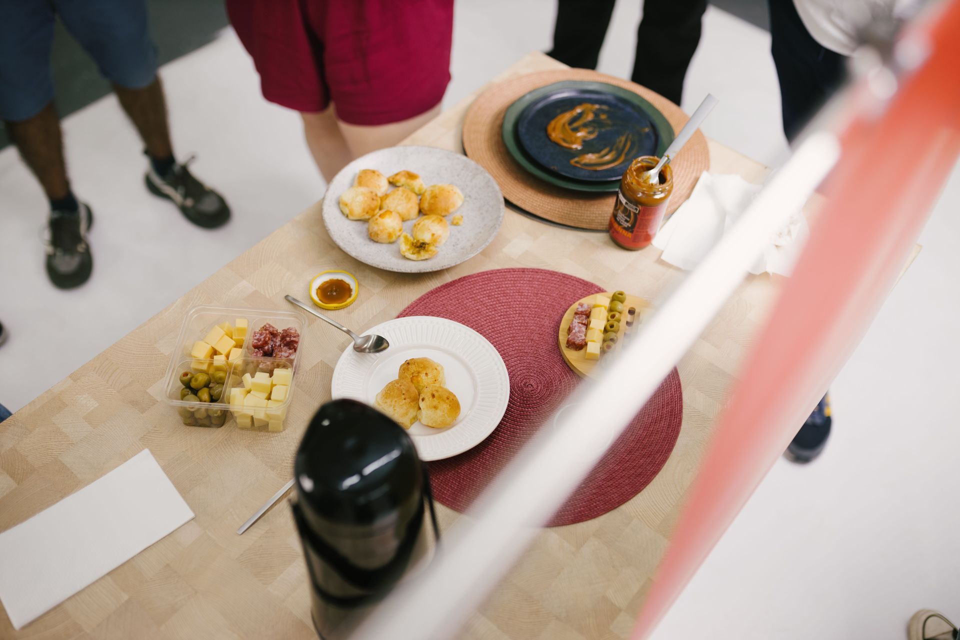 Overhead view of a table with assorted snacks, bowls, and drinks at a social gathering