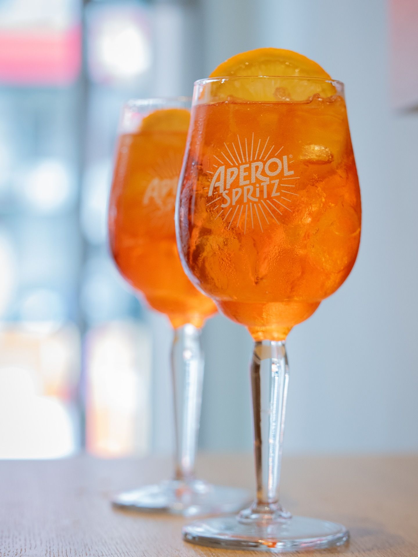 Two Aperol Spritz cocktails with orange slice garnish.Domenica 
Home made italian pastries, food & coffee 
