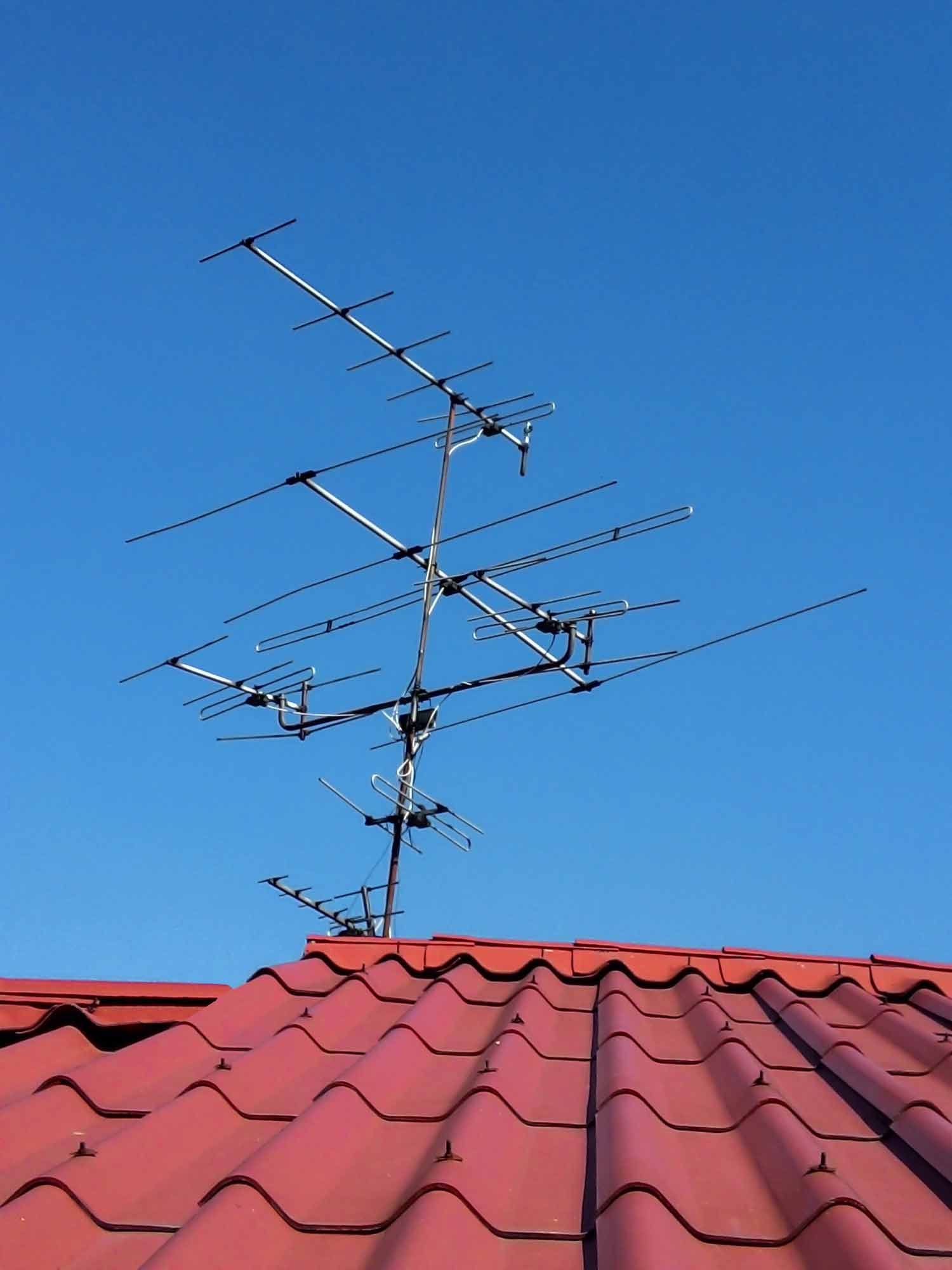 An antenna on top of a red tiled roof