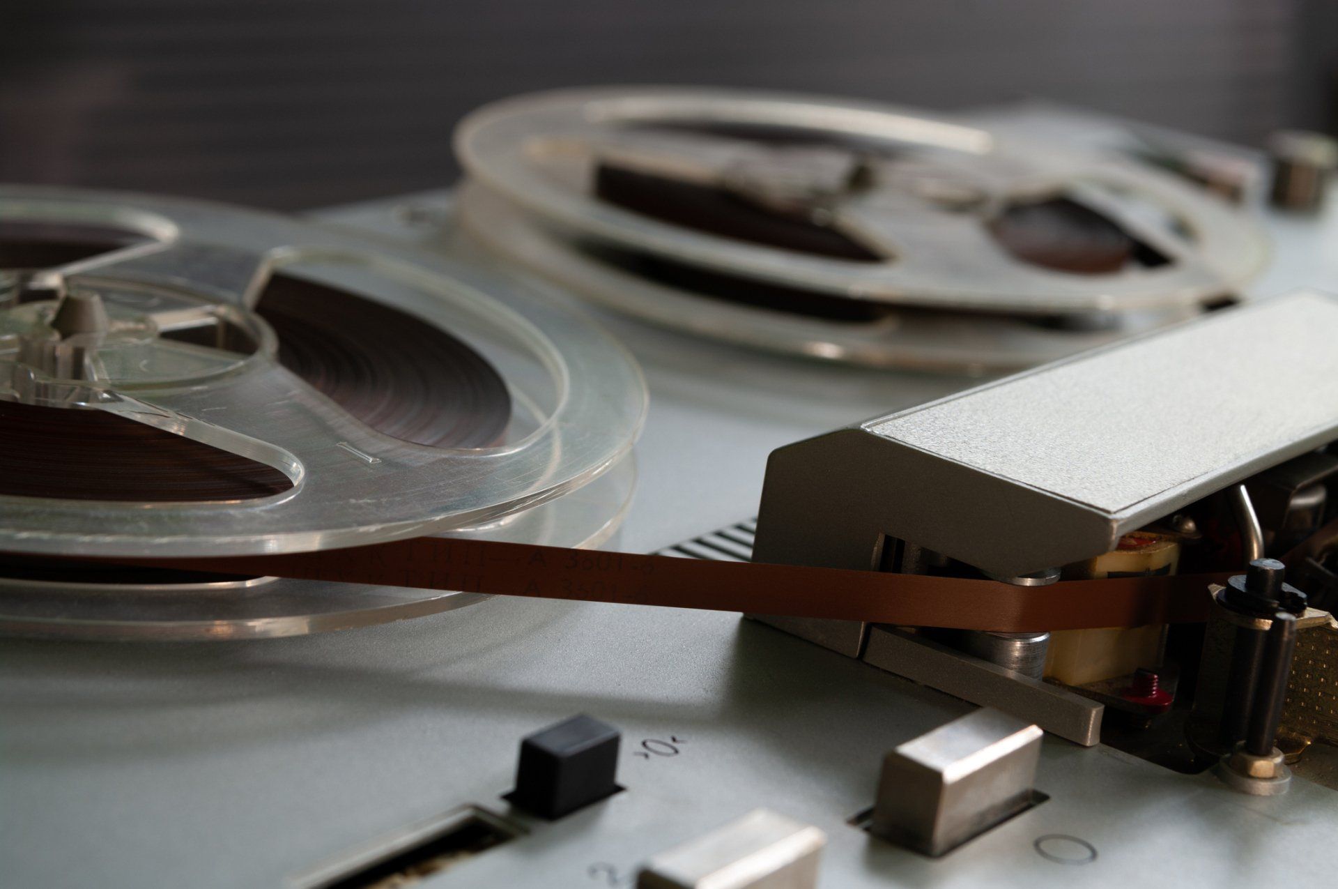 A close up of a tape recorder with two spools of tape on it.