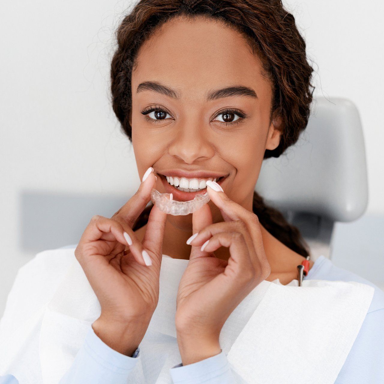 Happy Woman Holding Her Invisalign — Frankfort, IL — Brookside Dental Care Happy Woman Holding Her Invisalign — Frankfort, IL — Brookside Dental Care